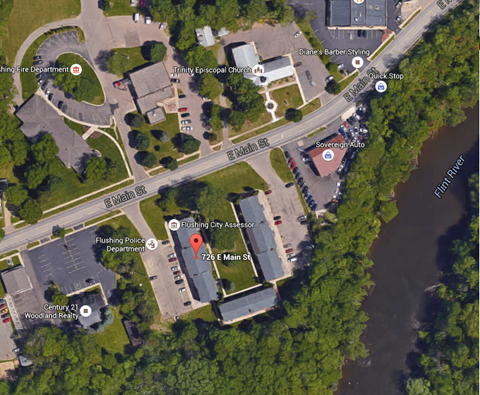 a map of a parking lot with a road and a building