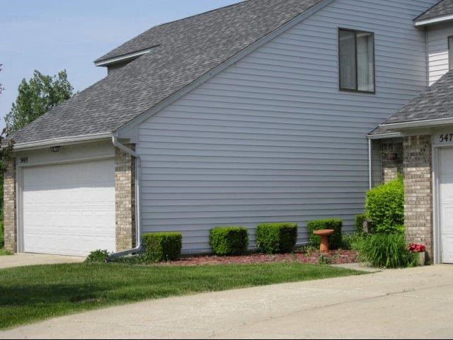 a blue house with a white garage door