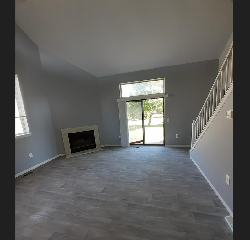 a living room with gray walls and a fireplace