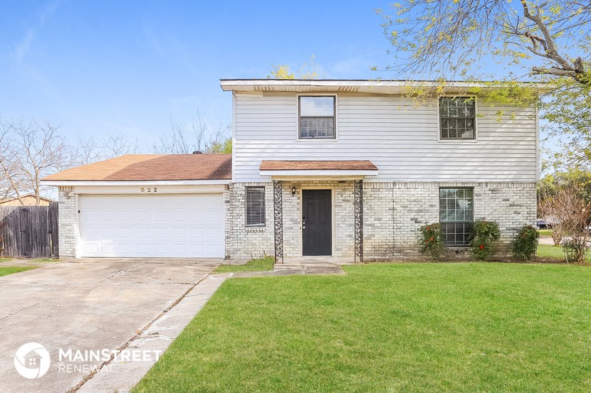 a white house with a yard and a white garage door
