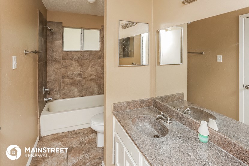 a bathroom with a sink and a shower and a toilet