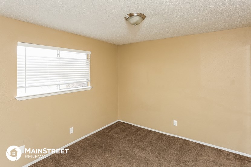 the bedroom of the bridgewater condos with carpet and a window