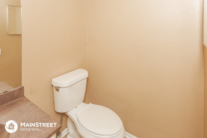 the bathroom has a toilet and a sink