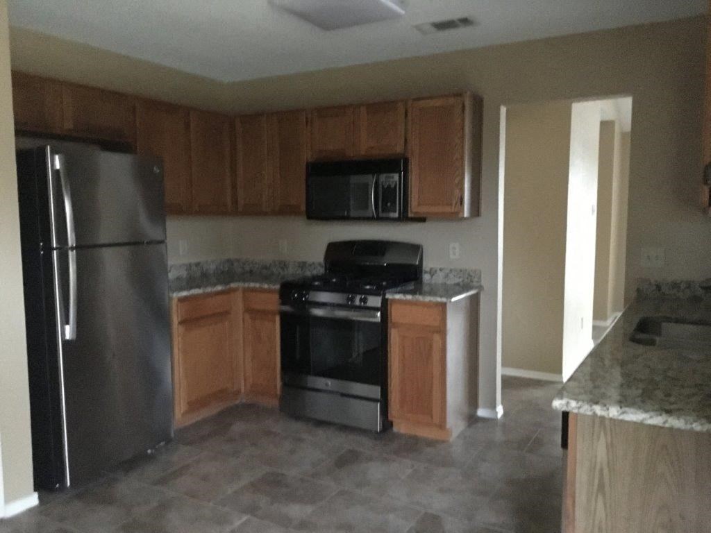 a kitchen with stainless steel appliances and wooden cabinets