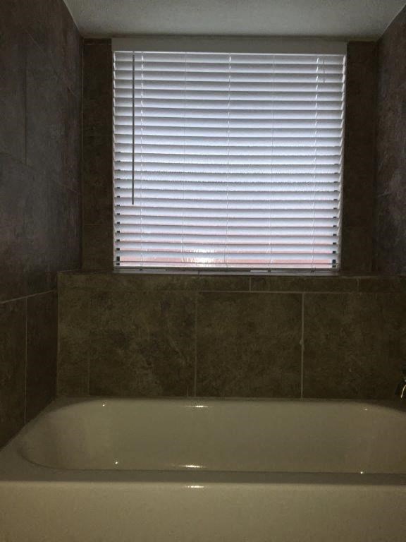 a bathroom with a bath tub and a window