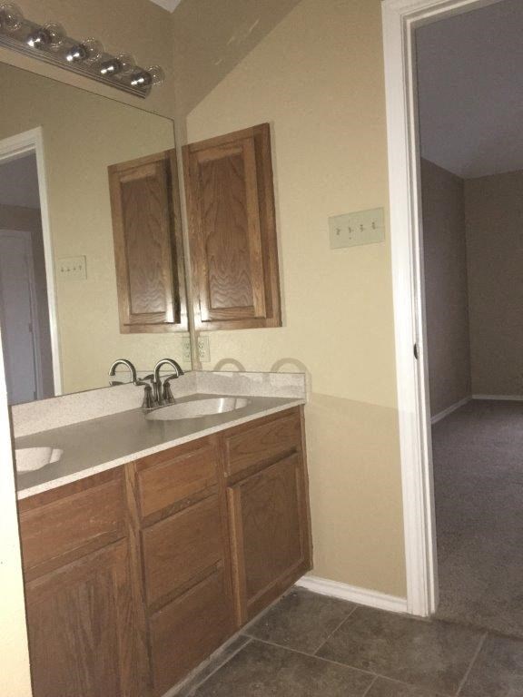 a kitchen with a sink and a mirror