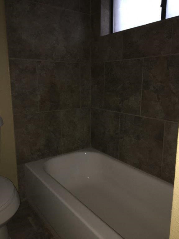 a bathroom with a bath tub and a toilet