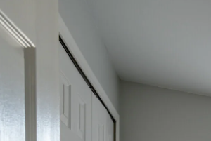 an empty room with a window and a door