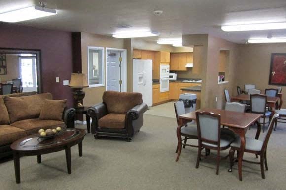 a living room and kitchen with a table and chairs