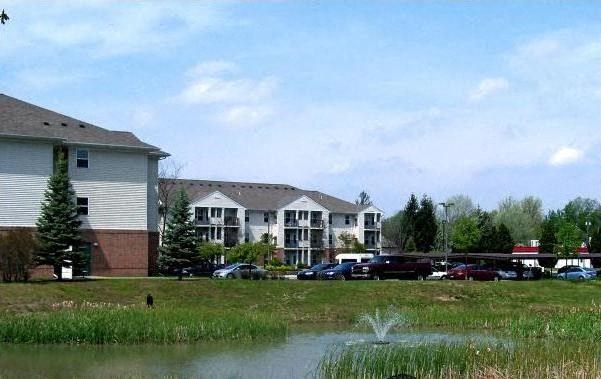 a parking lot with cars in front of houses