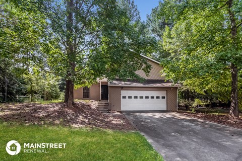 a house with a garage and some trees