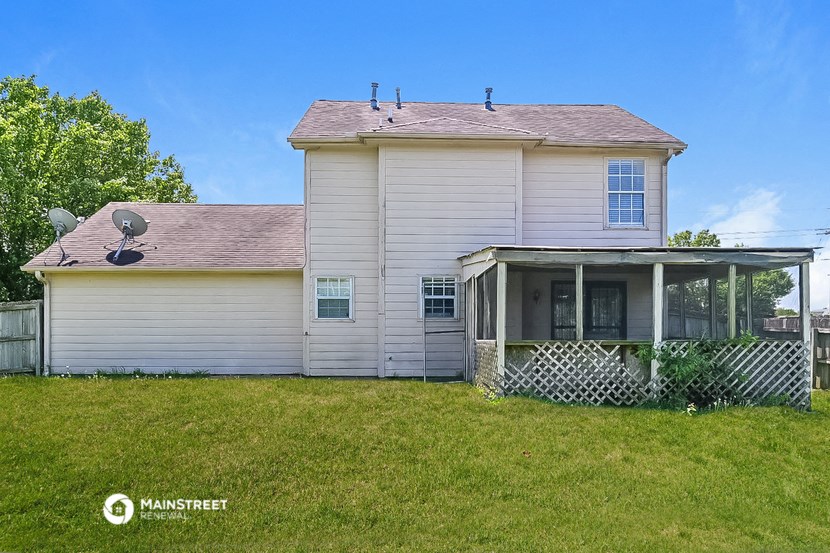 a white house with a satellite dish on the side of it