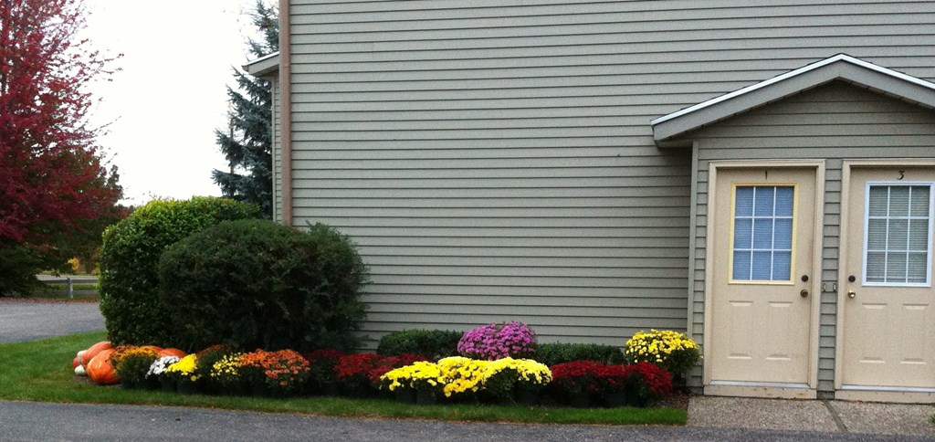 a house with a flower garden in front of it