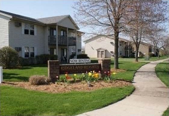 a sign in front of an apartment building