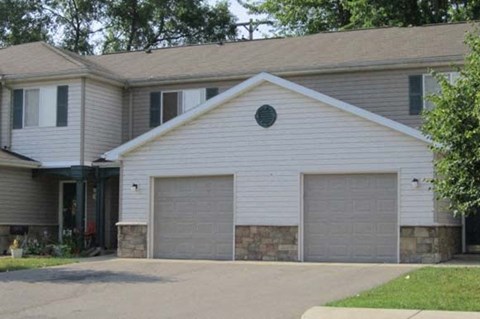 a white house with two garage doors