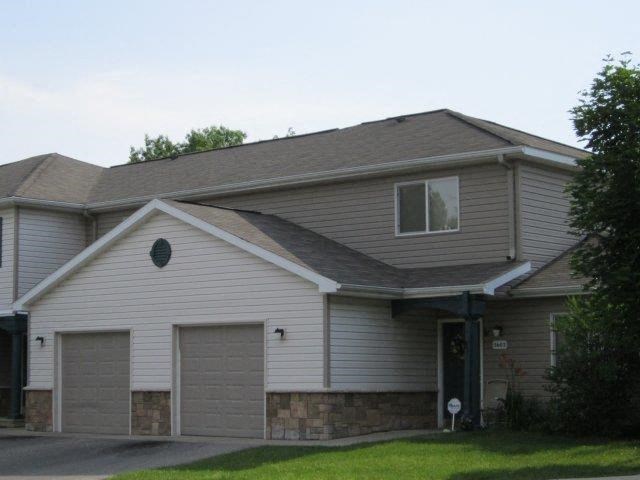 a white house with two garage doors