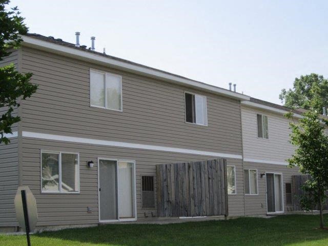a house with a wooden fence in front of it