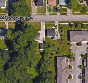 an aerial view of the parking lot of a city street