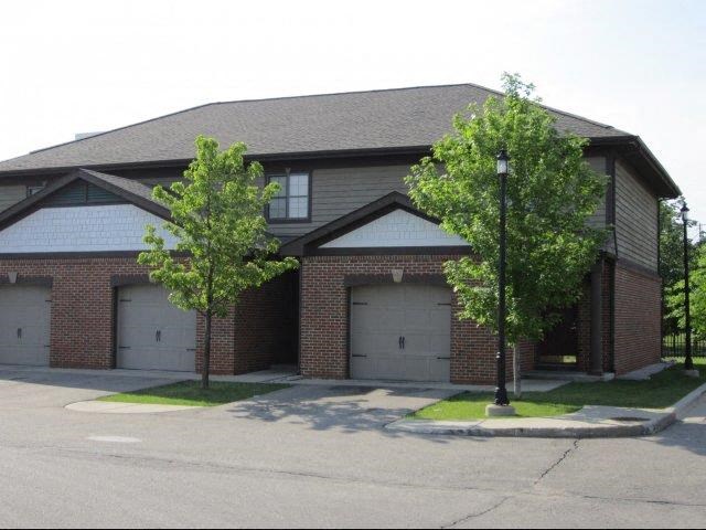 a brick house with two garage doors