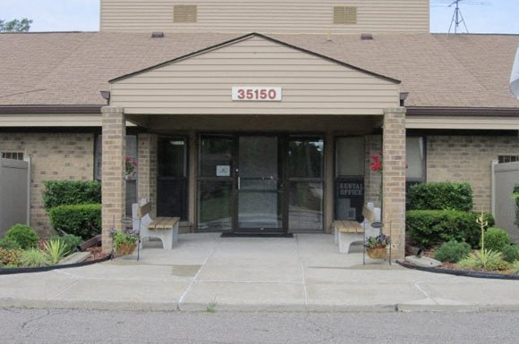 the front of a building with a door and a sign on it