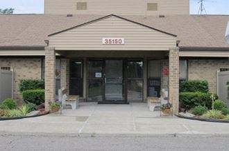 a building with two chairs in front of it