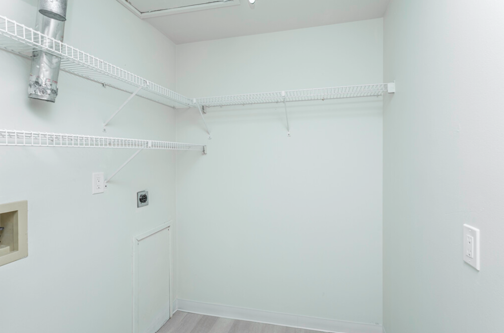 an empty room with a white wall and a white door