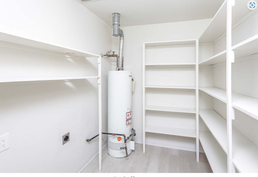 a white room with a water heater in the middle of it