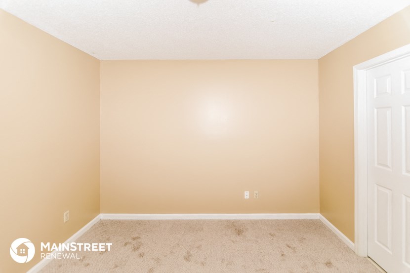 the upstairs bedroom has a carpeted floor and two closets