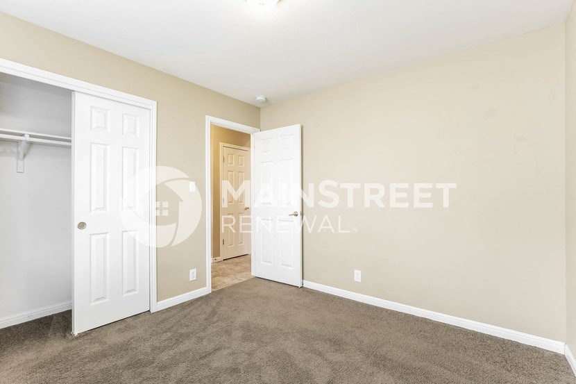 a bedroom with a closet and an open door