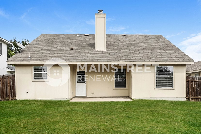 a small white house with the words main street renovation on the side