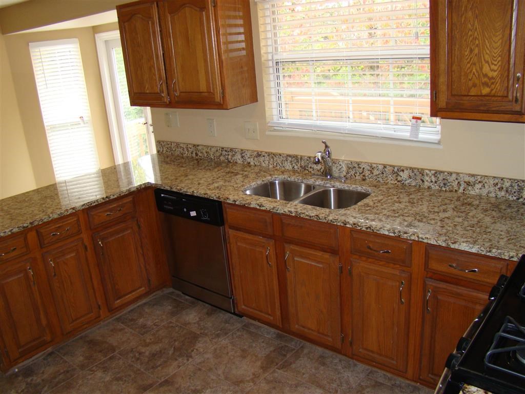 a kitchen with wooden cabinets and a sink