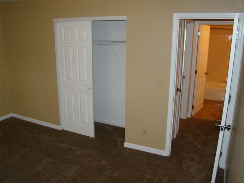 a bedroom with a closet and an open door