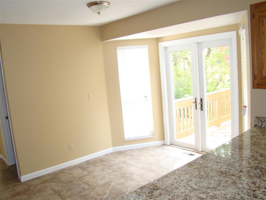 a dining room with a door to a balcony