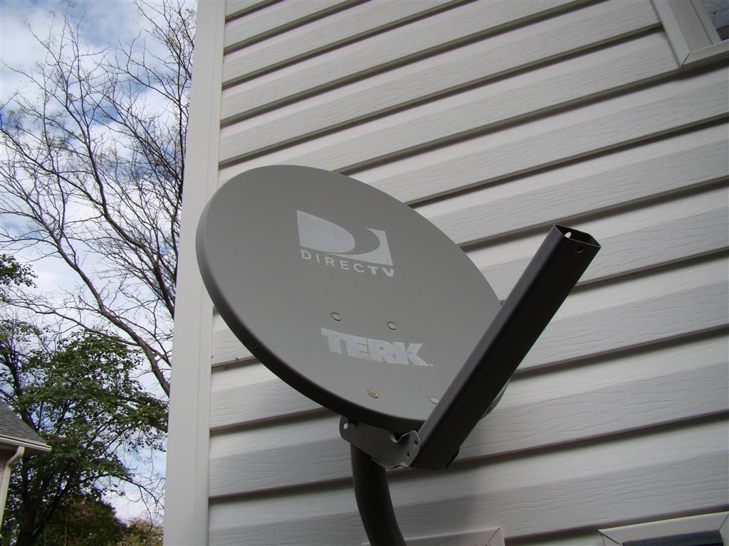a satellite dish on the side of a house