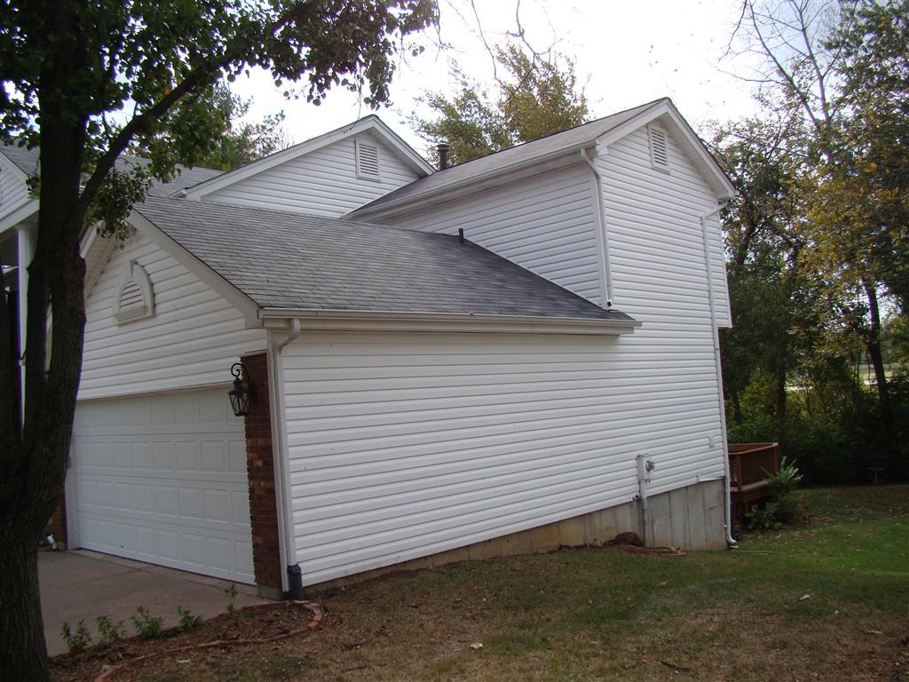 a view of the side of a house with a garage door
