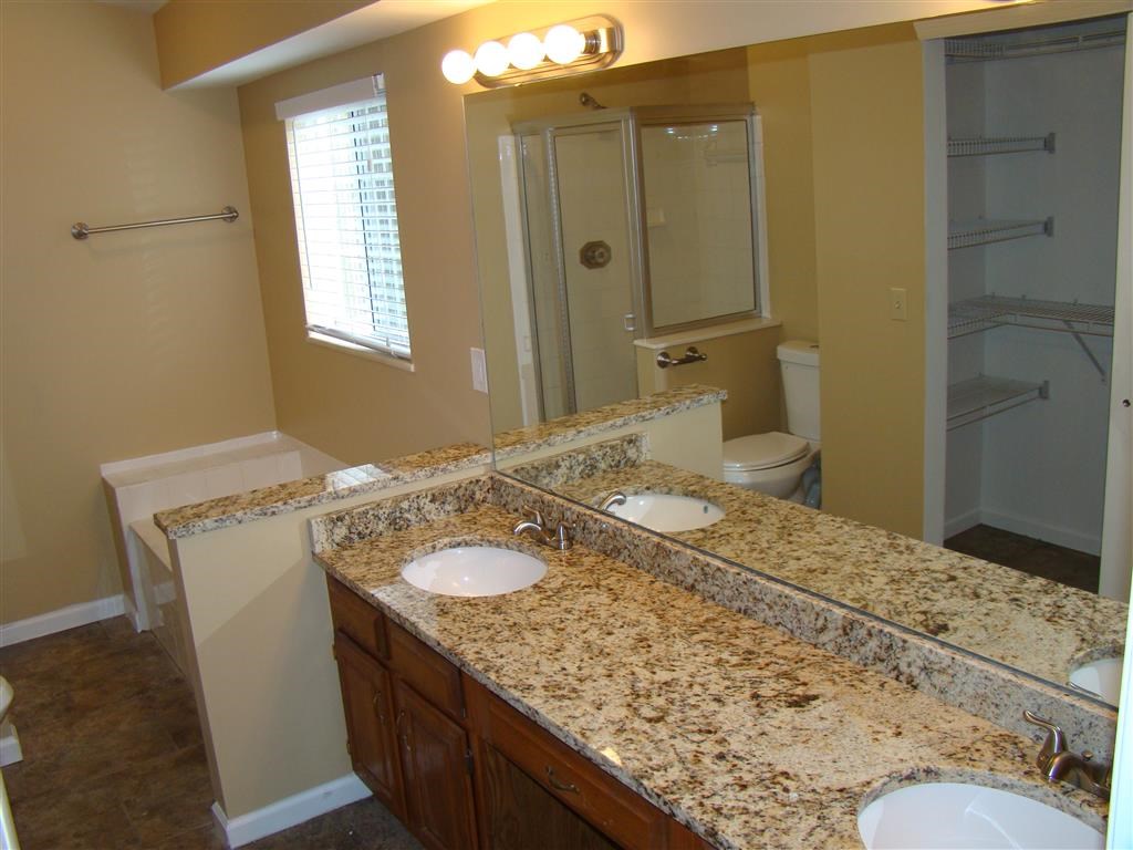 a bathroom with two sinks and a shower and a mirror