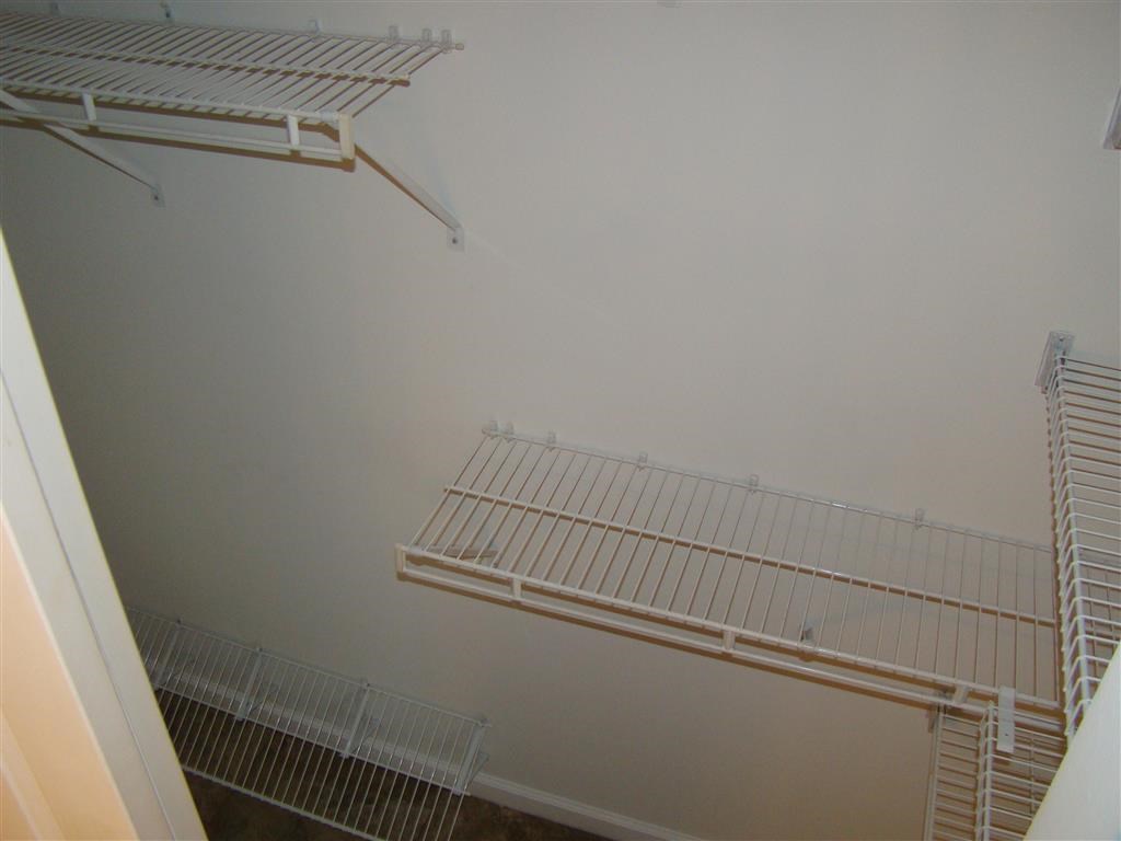 two white shelves on a wall in a room