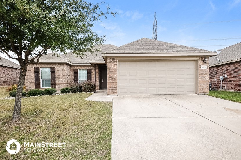 a small brick house with a white garage door