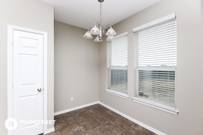 a bedroom with two windows and a white door