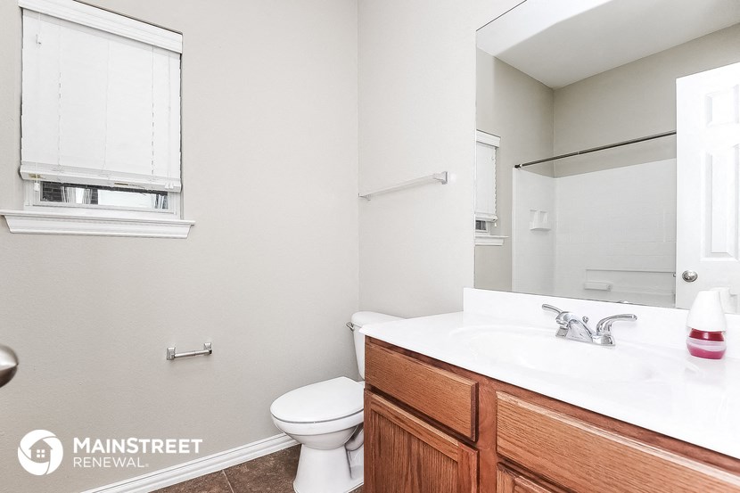 a bathroom with a sink and a toilet and a mirror
