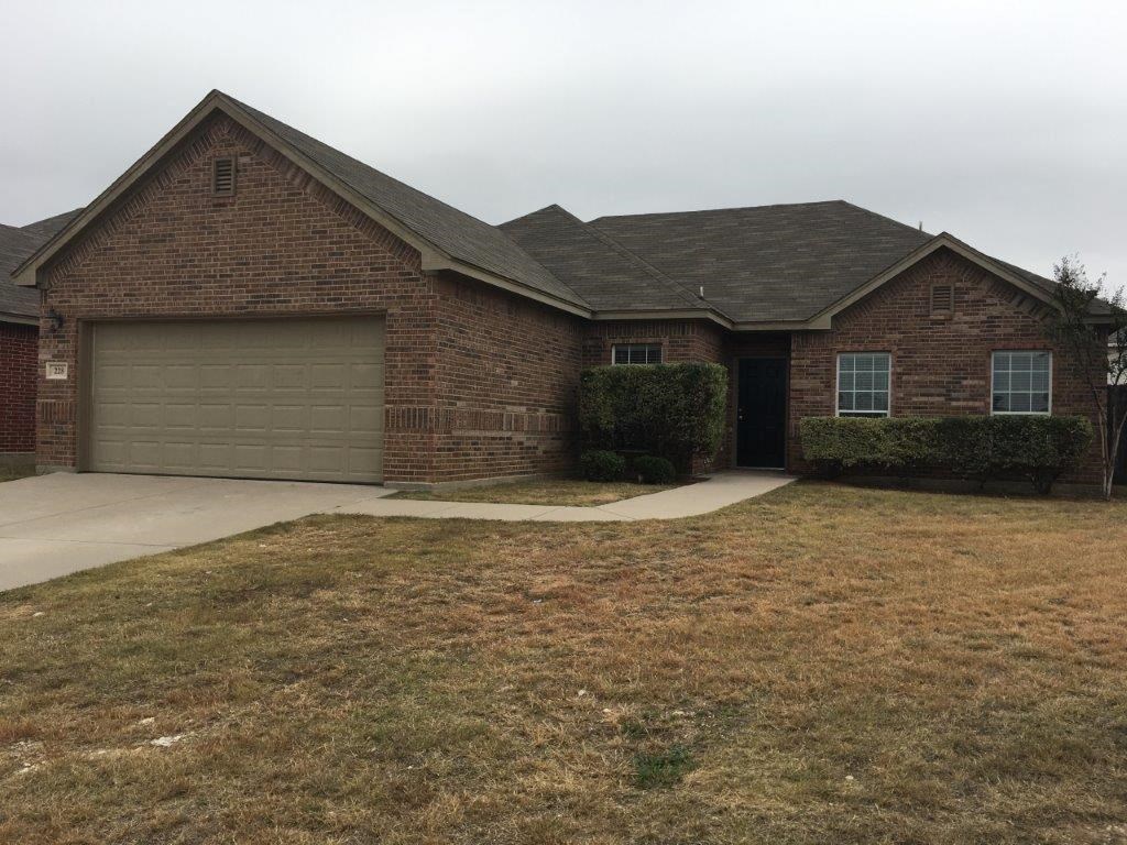 a brick house with a driveway and a garage door