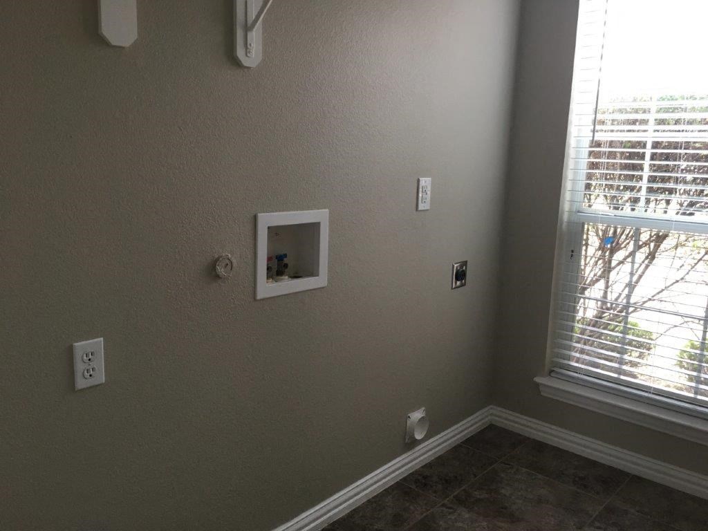 a picture on the wall next to a window in a room