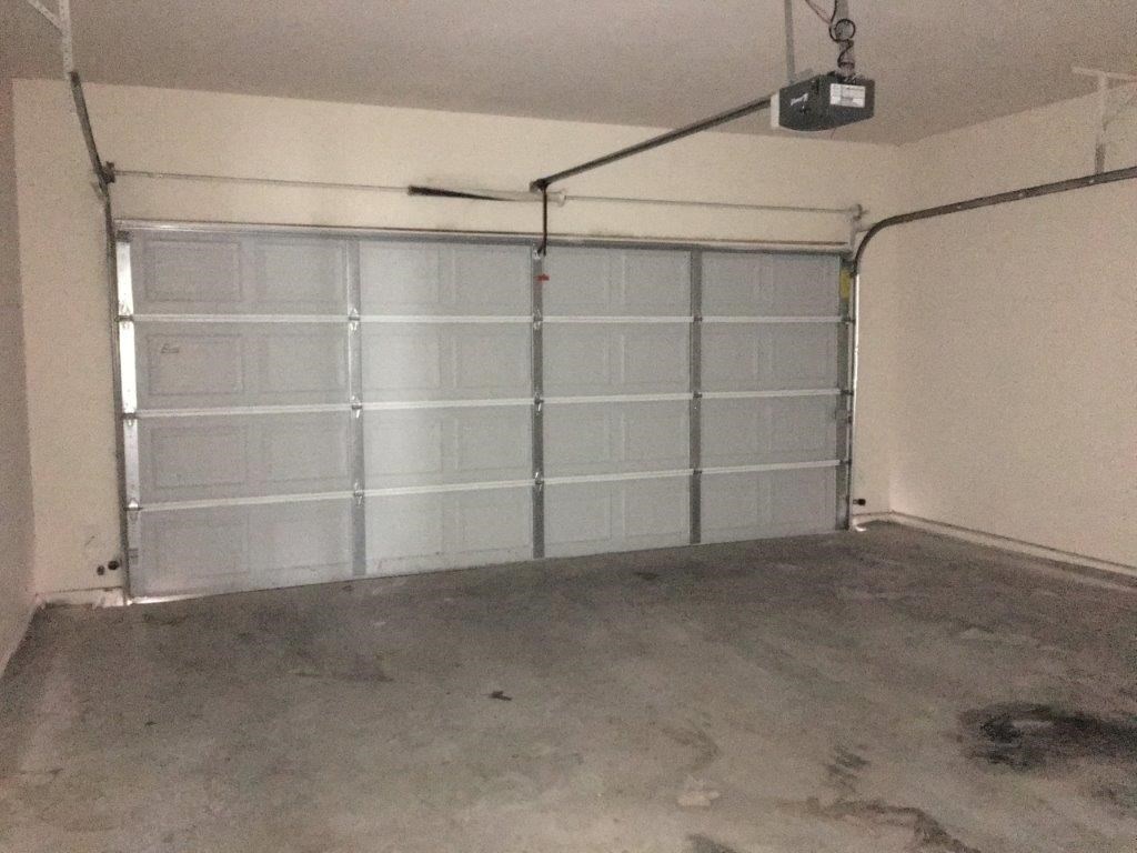 a garage with a clear door and cement floor