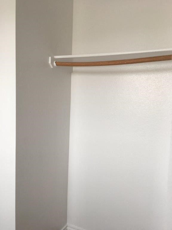 a white bathroom with a white shower curtain