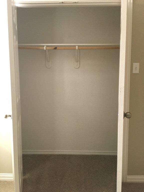 an empty closet in a room with a door