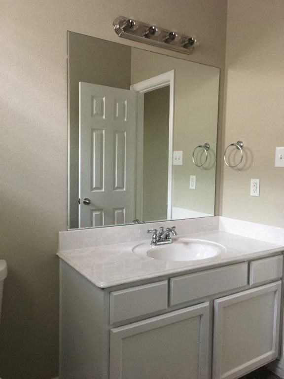 a bathroom with a white sink and a mirror