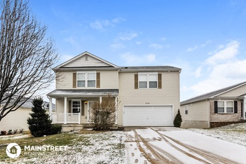 a beige house with snow on the ground
