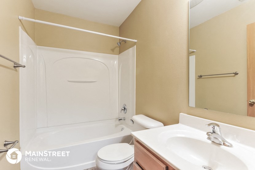 a bathroom with a sink toilet and a bath tub