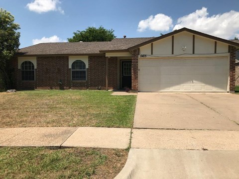 a house with a driveway and a garage door