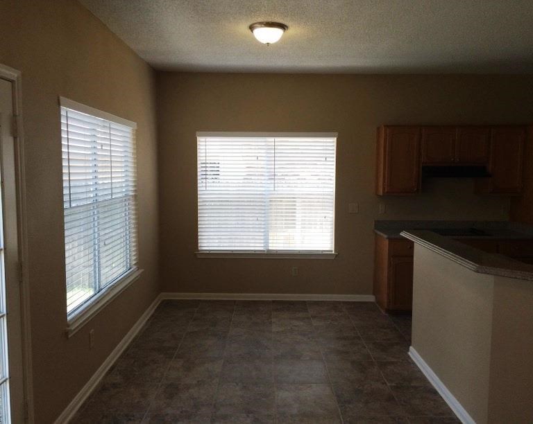an empty kitchen with a large window in it